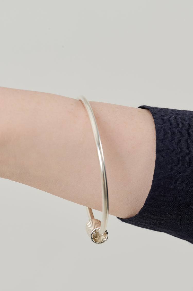 Sterling silver bangle in 3mm sterling silver wire with coil measuring 16mm long and 8mm wide