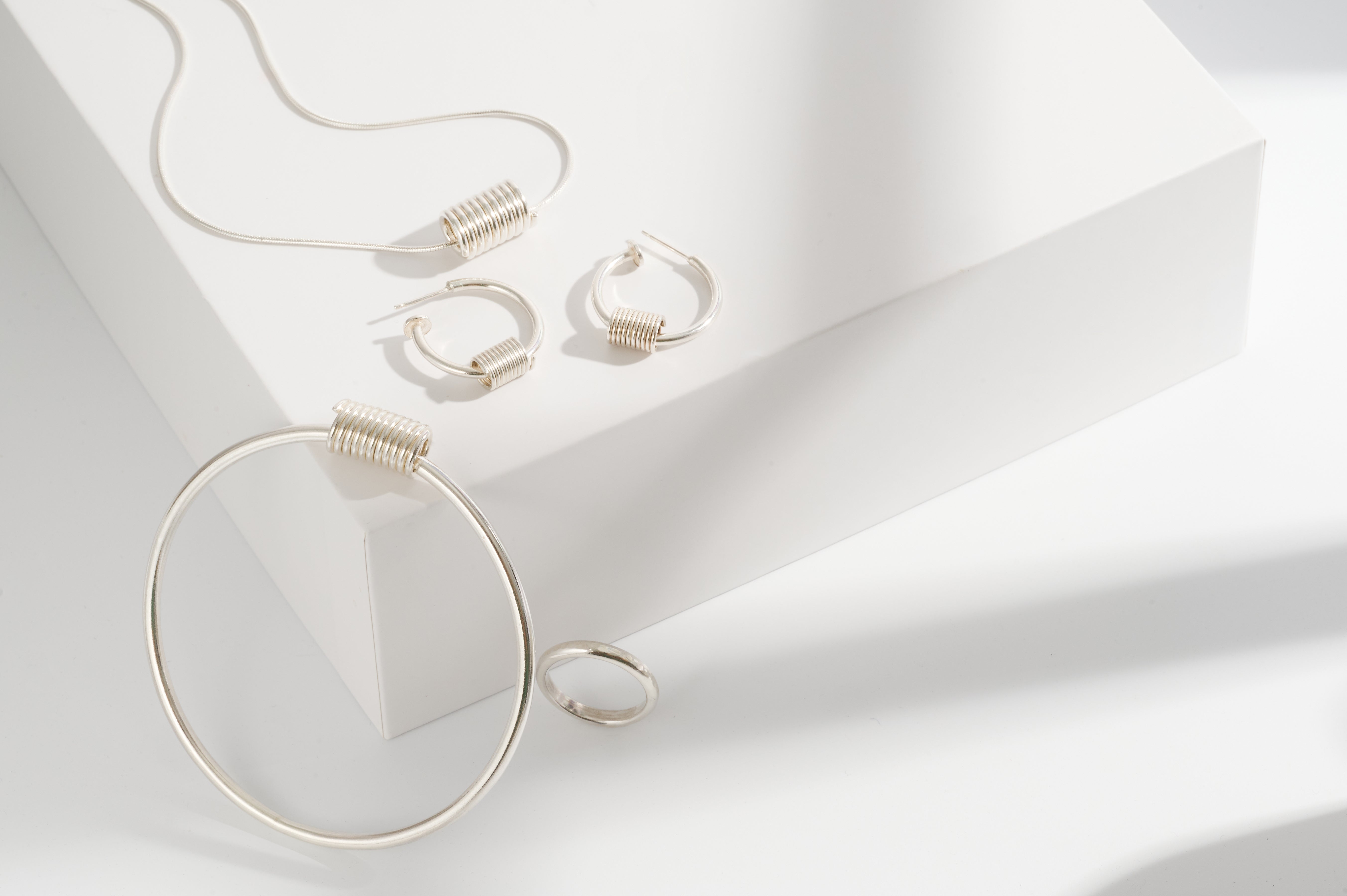 Sterling silver coil earrings, necklace and matching bangle and sterling silver textured ring