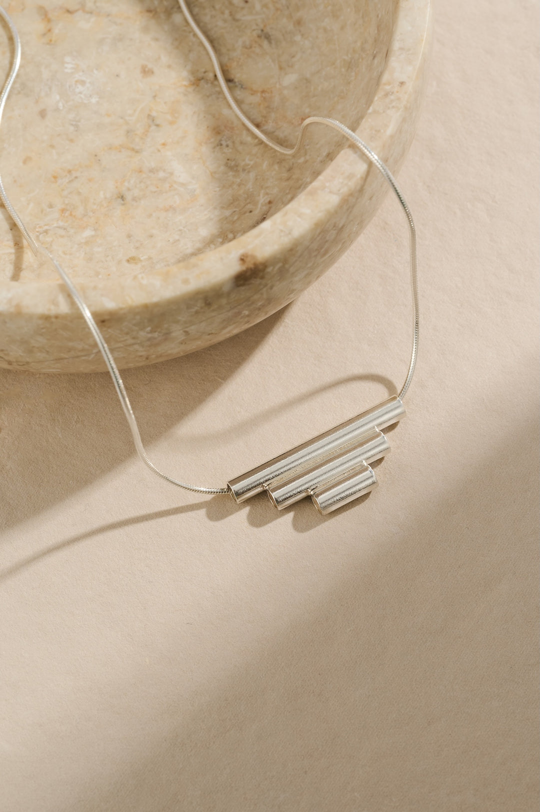 Sterling silver tube necklace of 3cm, 2cm and 1cm tubes joined together in descending size order and hung on a 40cm sterling silver chain