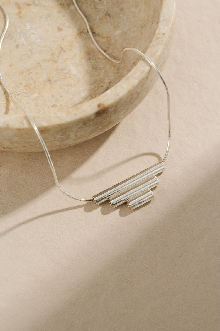 Sterling silver tube necklace of 3cm, 2cm and 1cm tubes joined together in descending size order and hung on a 40cm sterling silver chain